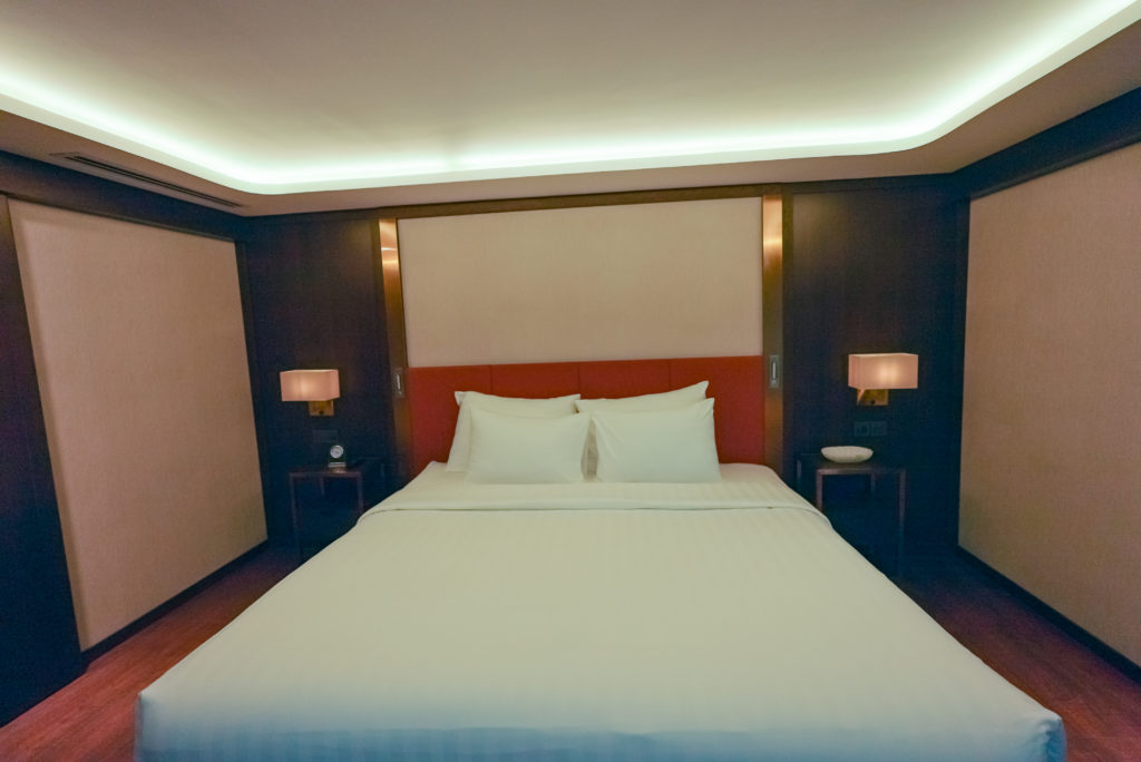 Queen bed in the suite of the APT Mekong Serenity